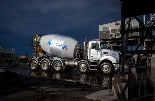 Austmix-branded Cesco mixer at a batching plant at dusk