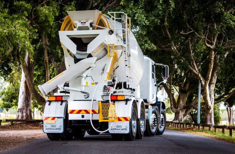 Cesco transit mixer driving along a tree-lined avenue