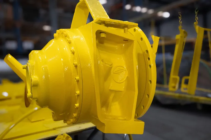 Close-up of a freshly painted yellow mixer gearbox housing