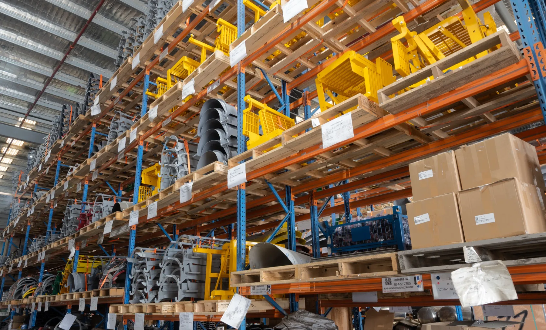 Cesco spare parts warehouse racking stocked with mixer chutes, hoppers and ladders