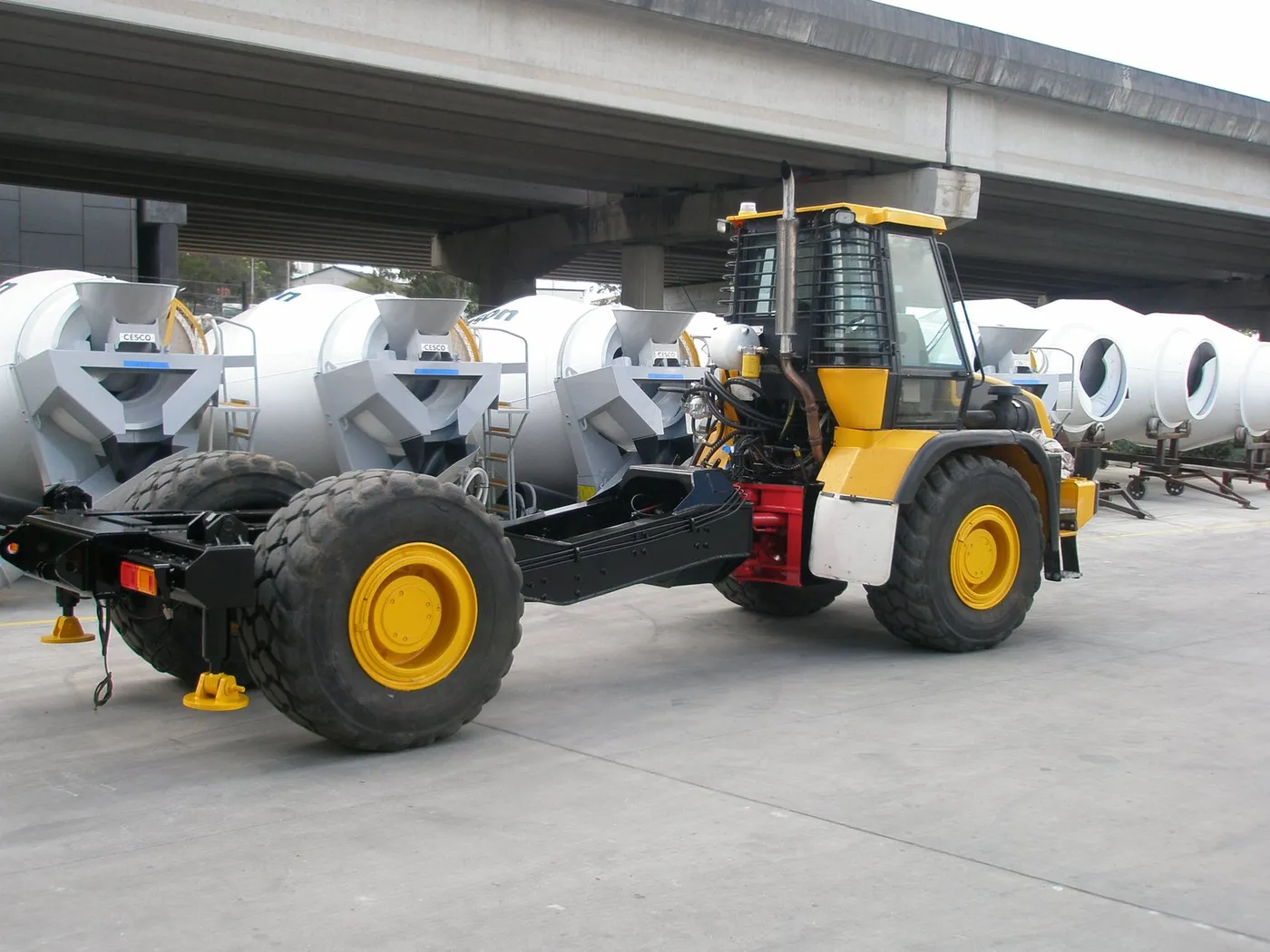 The JCB with its articulated rear section replaced by a purpose-built low frame, parked in front of Cesco barrels