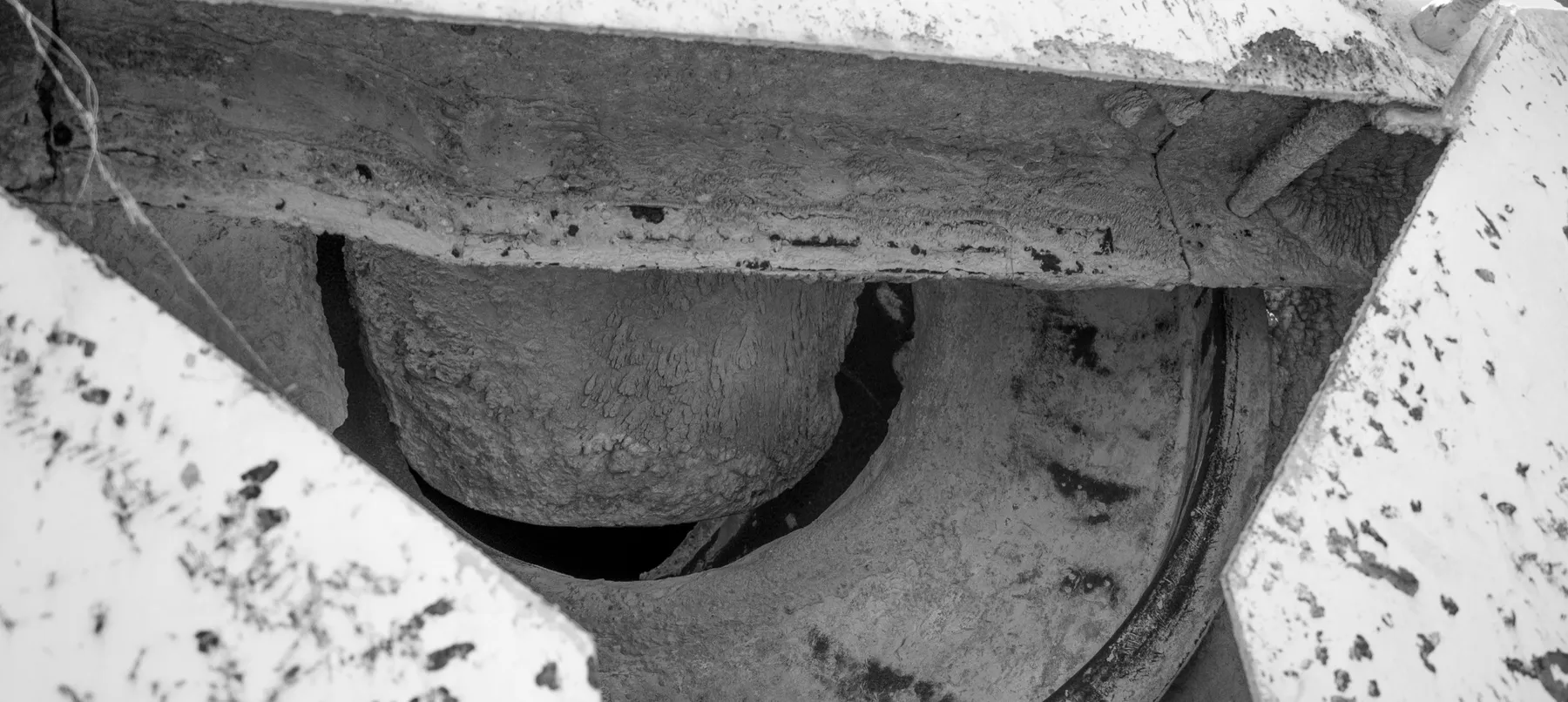 Concrete build-up on the blades inside a used concrete mixer barrel