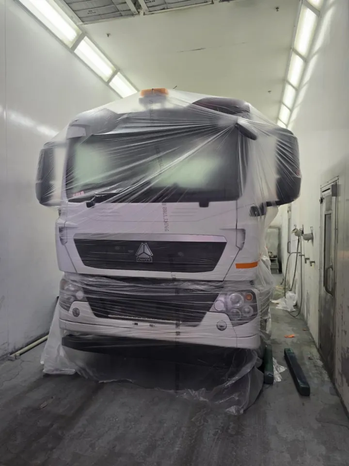 A truck cab masked and wrapped in the paint booth