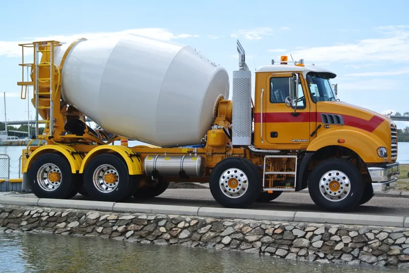 Cesco transit mixer on a Mack chassis parked beside a seawall