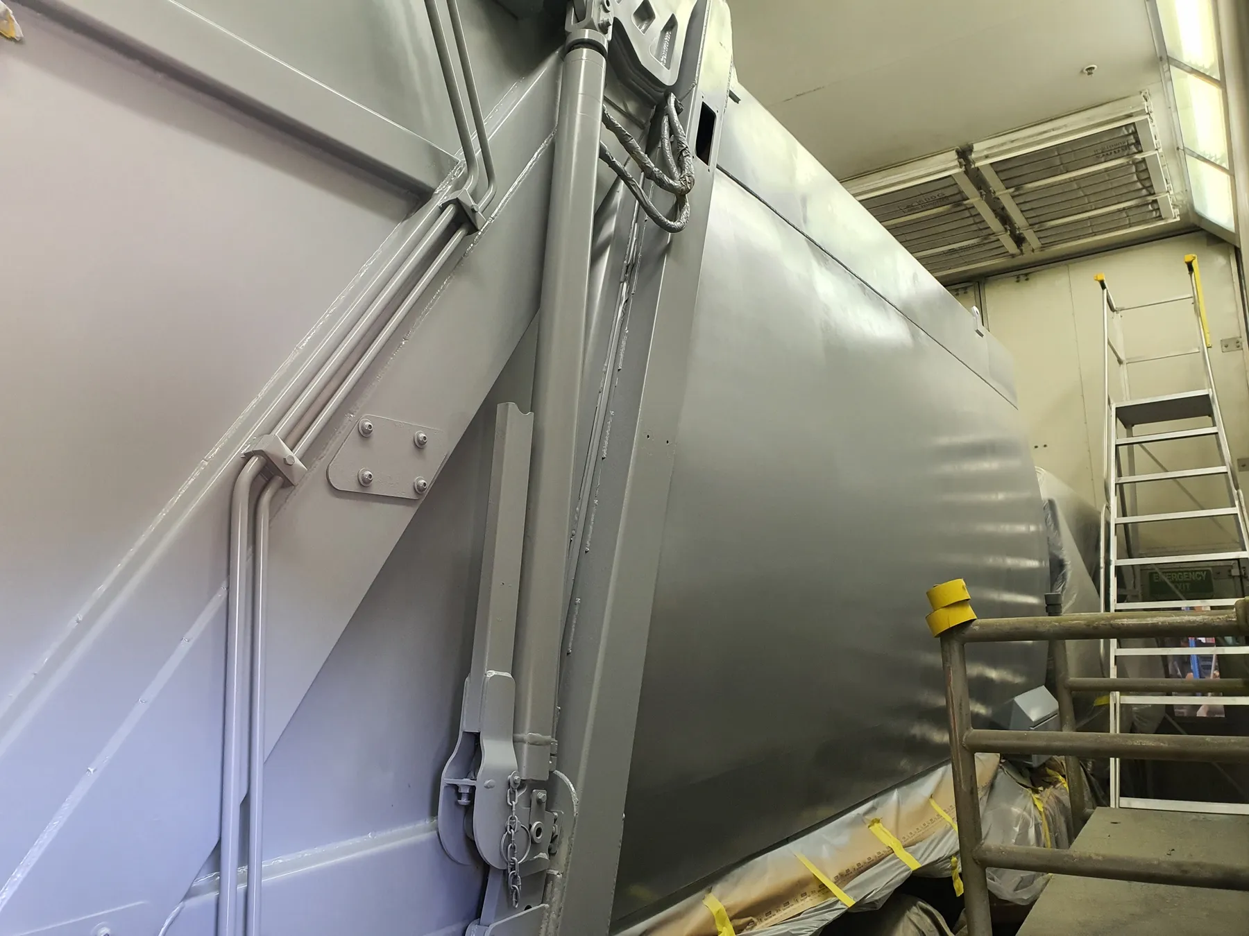 A truck body freshly painted grey in the Cesco paint booth